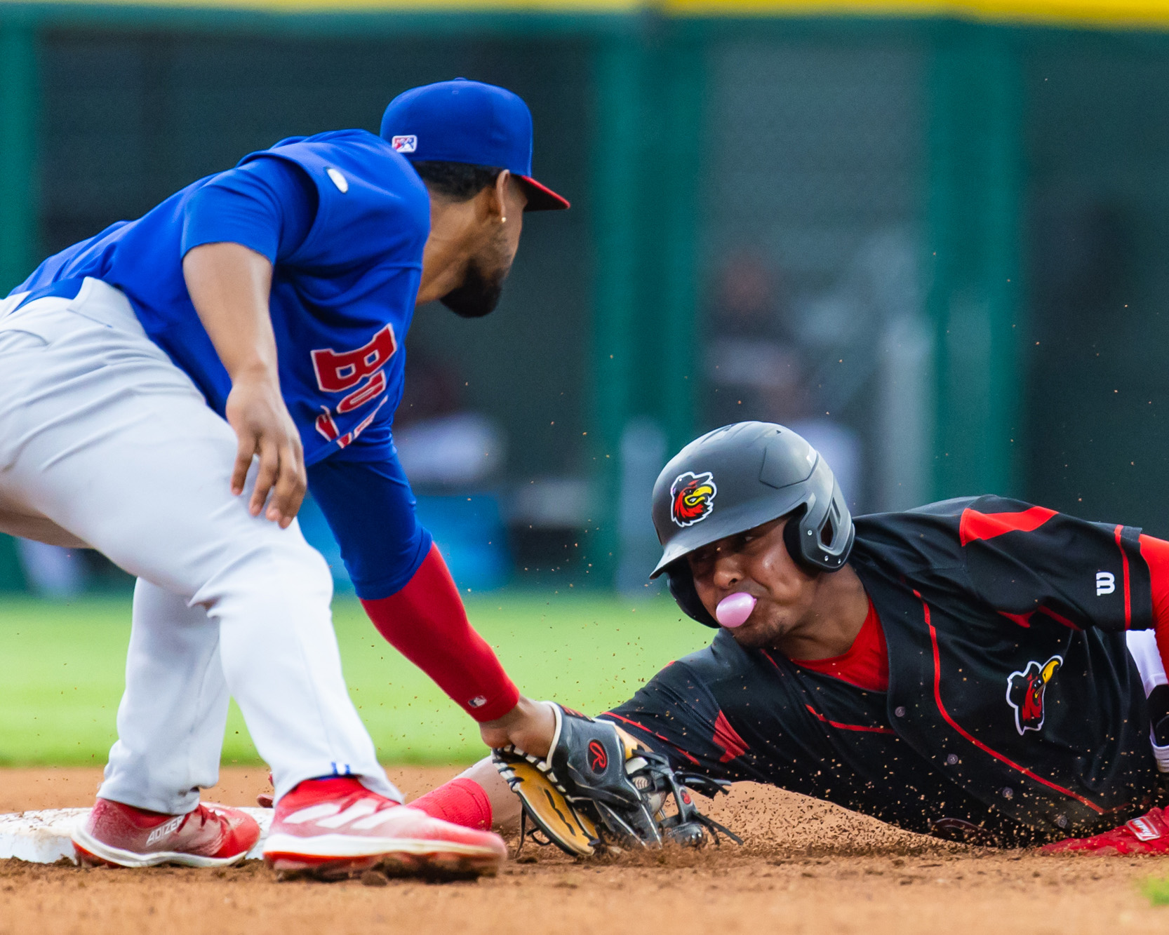 red wings player slides into second base against bisons