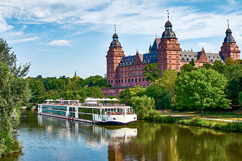 Viking River Cruise Summer Sale river boat cruising down stream in front of a castle
