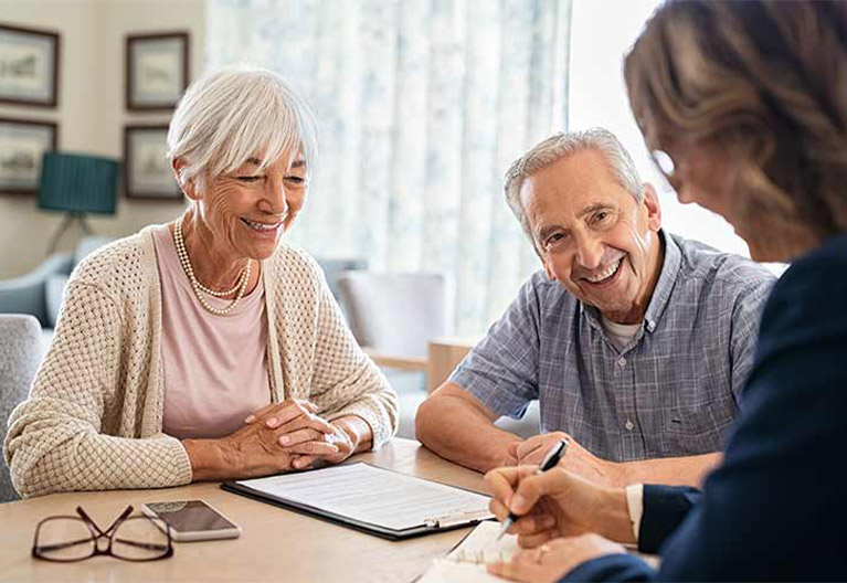 two seniors discussing insurance plan with an insurance advisor