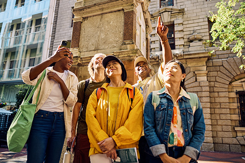 group of travelers outside of brick building