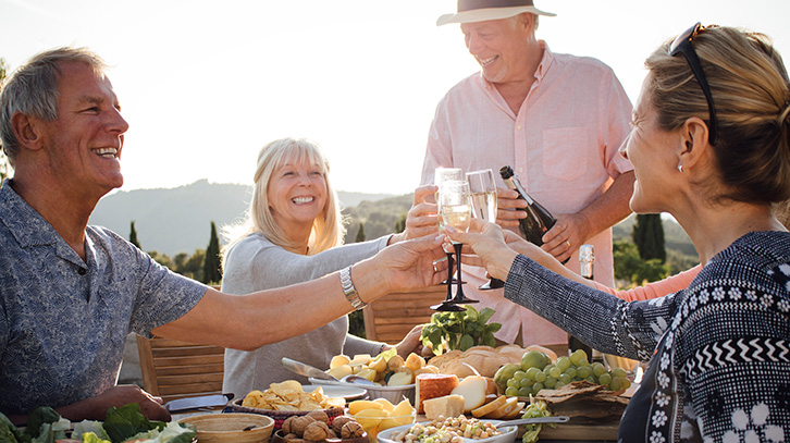 a group of middle aged people sharing a meal