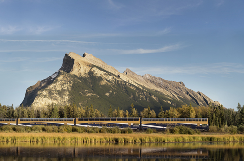 Rocky Mountaineer train passes by a large rock formation