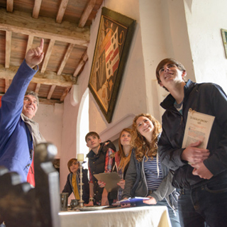 students listening to a tour guide